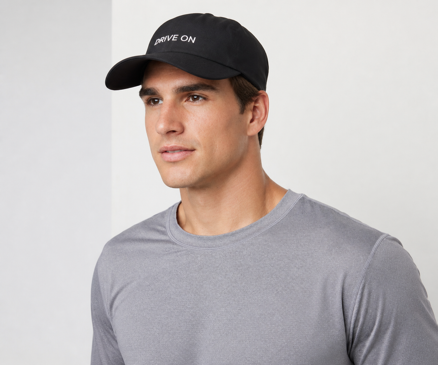 Man in a black DRIVE ON cap and grey tee